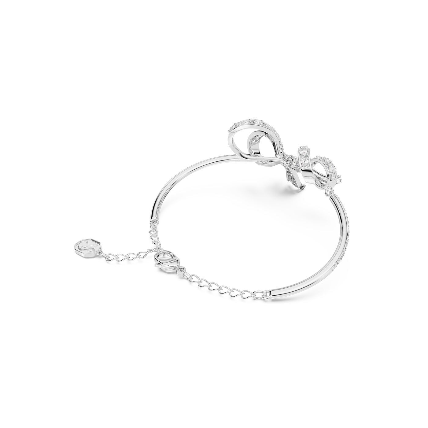 The Swarovski Volta Bow Bangle by Swarovski features an exquisite bow design adorned with pavé clear crystals. This rhodium-plated piece of jewelry exudes sophistication and elegance with its delicate chain and small round clasp closure.