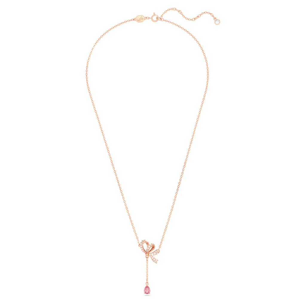 Introducing the Swarovski Hyperbola Y Necklace Pendant, a charming rose gold piece by Swarovski. This elegant necklace showcases a heart-shaped charm embellished with small diamonds, complemented by a dangling pink teardrop gemstone and a petite star charm for added sophistication—an ideal romantic gift for any occasion.