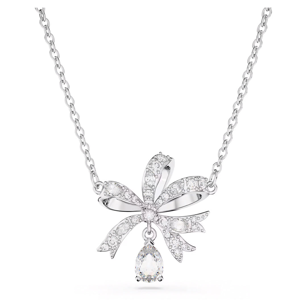 The Swarovski Hyperbola Necklace Pendant features a sophisticated ribbon-shaped pendant embellished with clear crystals, highlighting its elegance. Beneath the ribbon hangs a teardrop-shaped crystal. The straightforward rhodium-plated chain enhances the intricate design of the pendant.