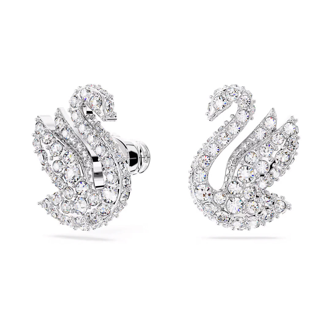 A pair of Swarovski Swan Stud Earrings, crafted by the renowned brand Swarovski, featuring a radiant design with numerous small pavé crystals. The rhodium-plated finish showcases symmetrical craftsmanship, offering an elegant and intricate detailing that enhances their luxurious and sophisticated appeal.