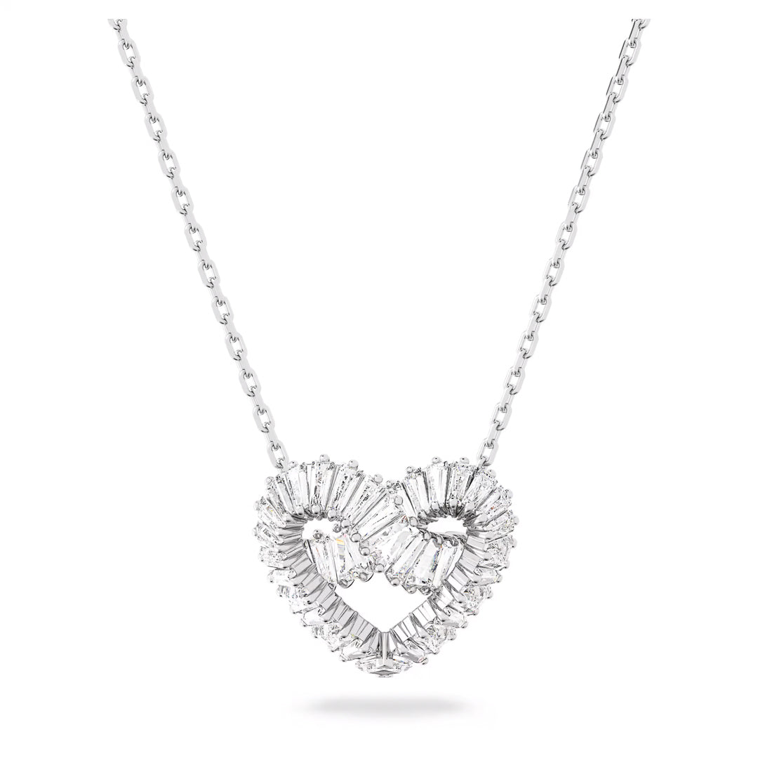 The Swarovski Matrix Necklace Pendant by Swarovski, featuring a rhodium-plated heart-shaped pendant adorned with sparkling crystals, creates a shimmering and elegant appearance against a plain white background.