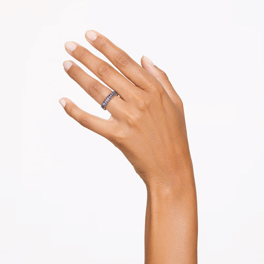 A close-up of a hand with neatly manicured nails showcasing the Swarovski Matrix Ring, featuring baguette-cut stones, on the ring finger against a plain white background.