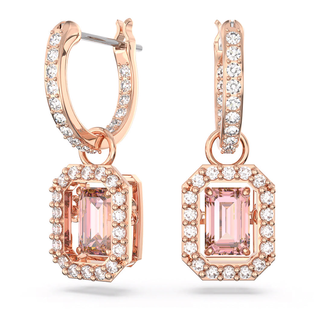The exquisite Swarovski Una Drop Earrings, designed by the renowned brand Swarovski, showcase pink rectangular gemstones surrounded by dazzling white stones in a graceful hoop design, capturing the essence of Swarovski's iconic craftsmanship and making them ideal for any occasion.
