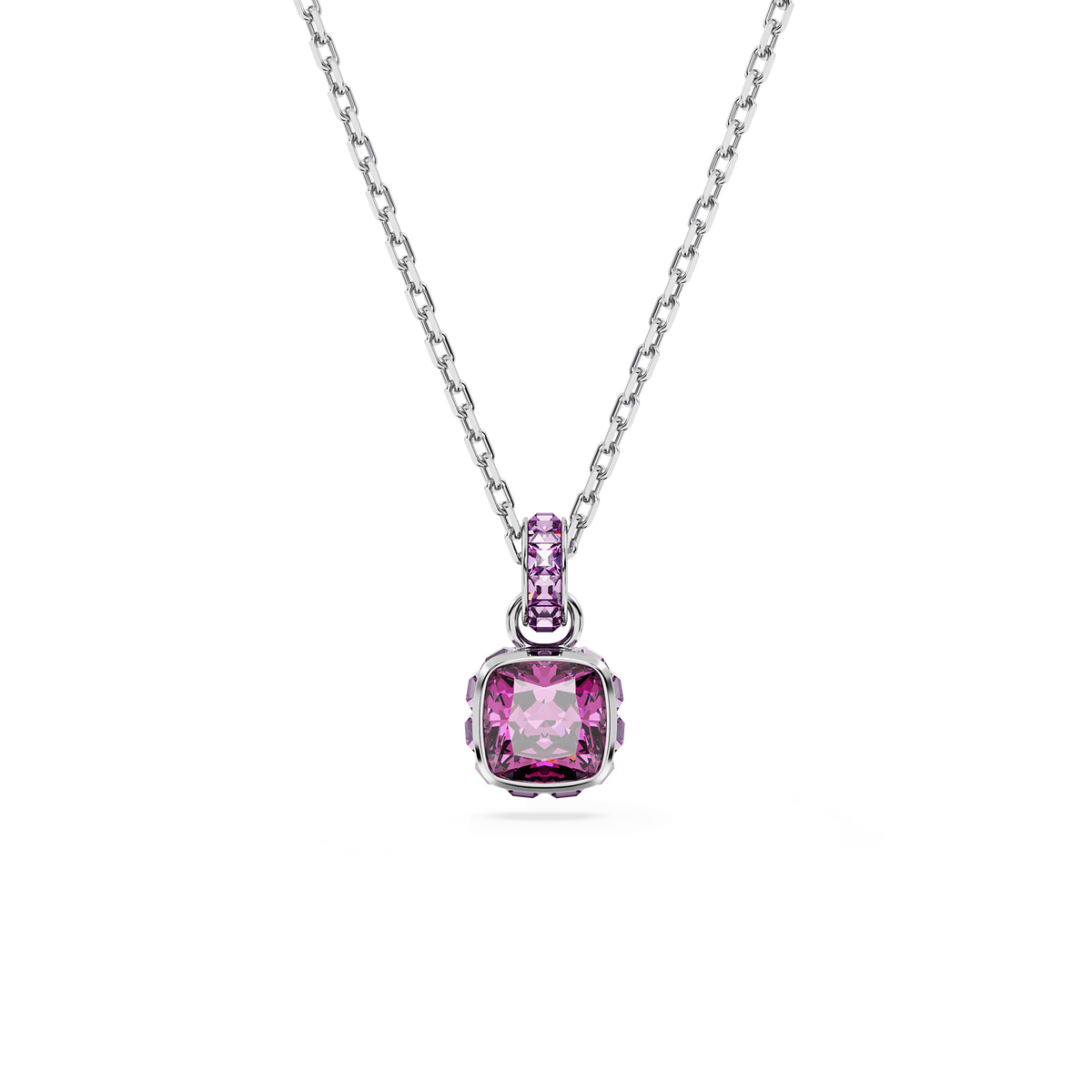 A rhodium-plated Swarovski Birthstone pendant for February features a square-cut purple gemstone, inspired by the brand’s iconic collection, and is showcased on a thin silver chain with a smaller purple stone above it, all set against a plain white background.
