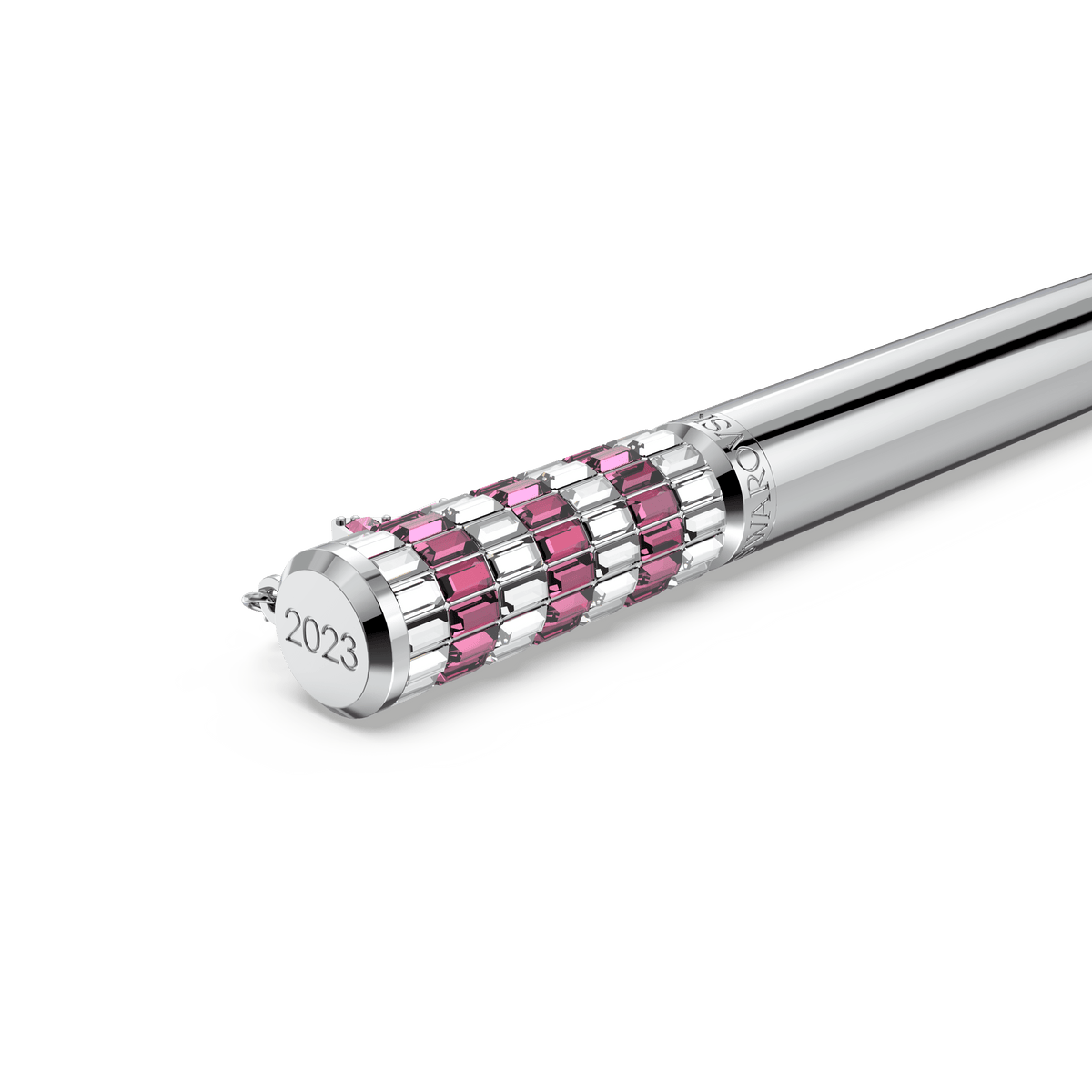 The Swarovski Celebration 2023 ballpoint pen Star, Pink, Chrome plated features “2023” engraved on the end and is adorned with alternating pink and clear rectangular gemstones near the cap in signature Swarovski style. The pen is displayed against a white background.