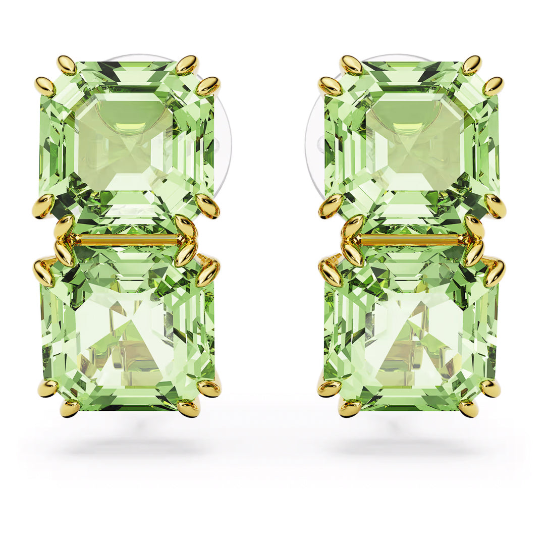 Two pairs of Swarovski Millenia Clip Earrings, each featuring light green emerald-cut stones stacked vertically and set in gold-tone prongs. The elegant Swarovski design highlights the clarity and color of the green crystals against a white background, presenting a classic and symmetrical beauty.