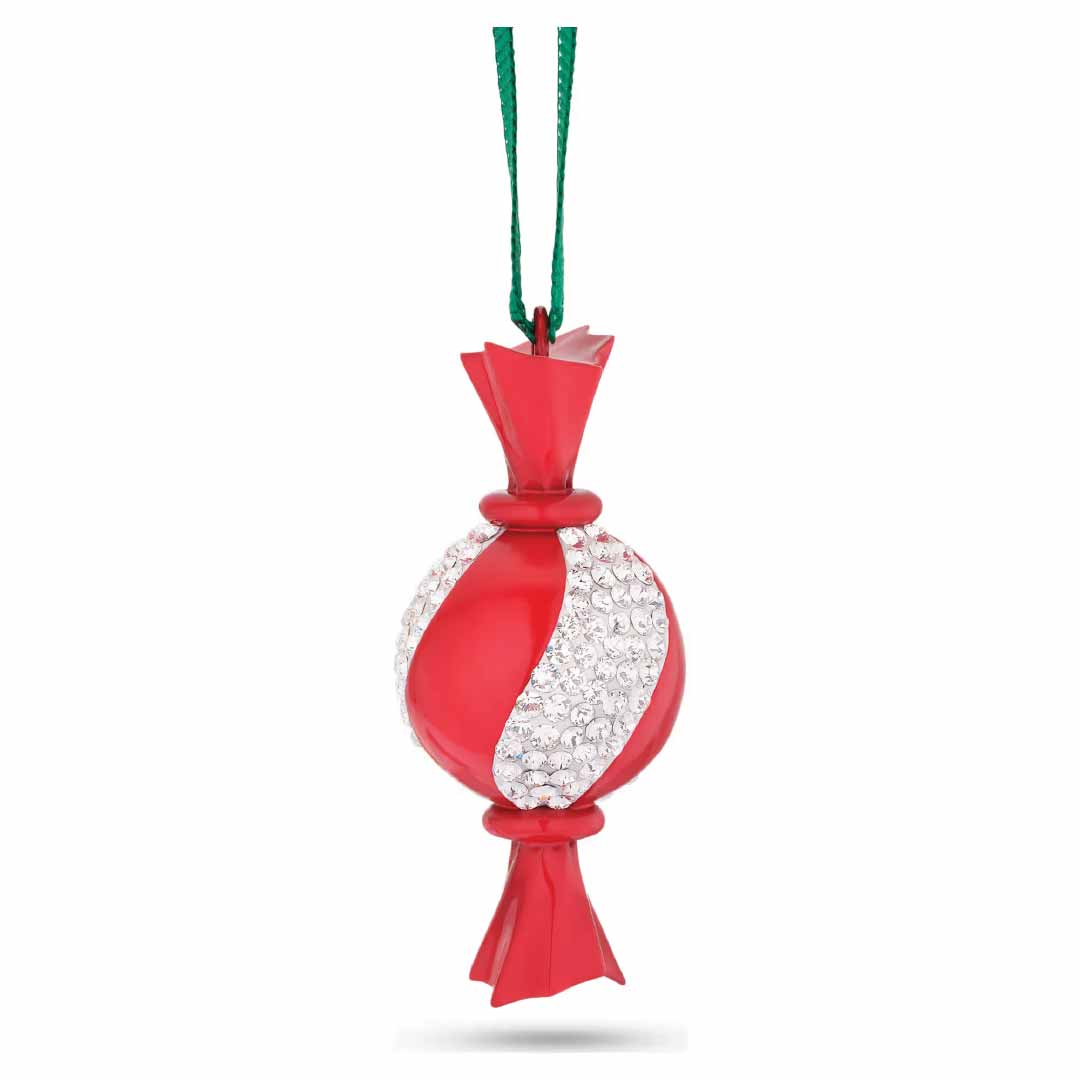 The Swarovski Holiday Cheers Dulcis Crystal Ornament from Swarovski features a festive candy figurine in red and white stripes, hanging by a green string, with its white bands adorned with small, sparkling crystal beads.