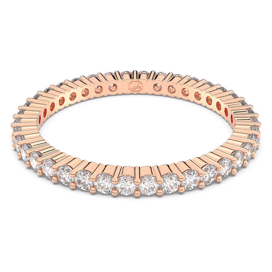 The Swarovski Vittore Ring dazzles with its expertly crafted rose gold-tone finish, featuring a sophisticated arrangement of alternating round and baguette-cut crystals from Swarovski that encircle the entire band, highlighting its intricate design and radiant brilliance.