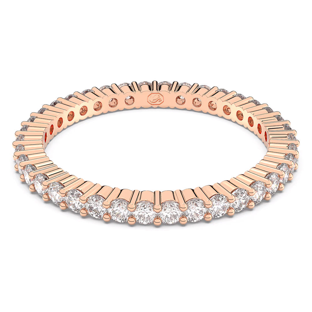 The Swarovski Vittore Ring, by Swarovski, is a rose gold-tone eternity ring that features a continuous line of clear round stones set in a sleek and modern design. With its intricate craftsmanship and alternating gemstone pattern, it draws inspiration from the Matrix Vittore ring.