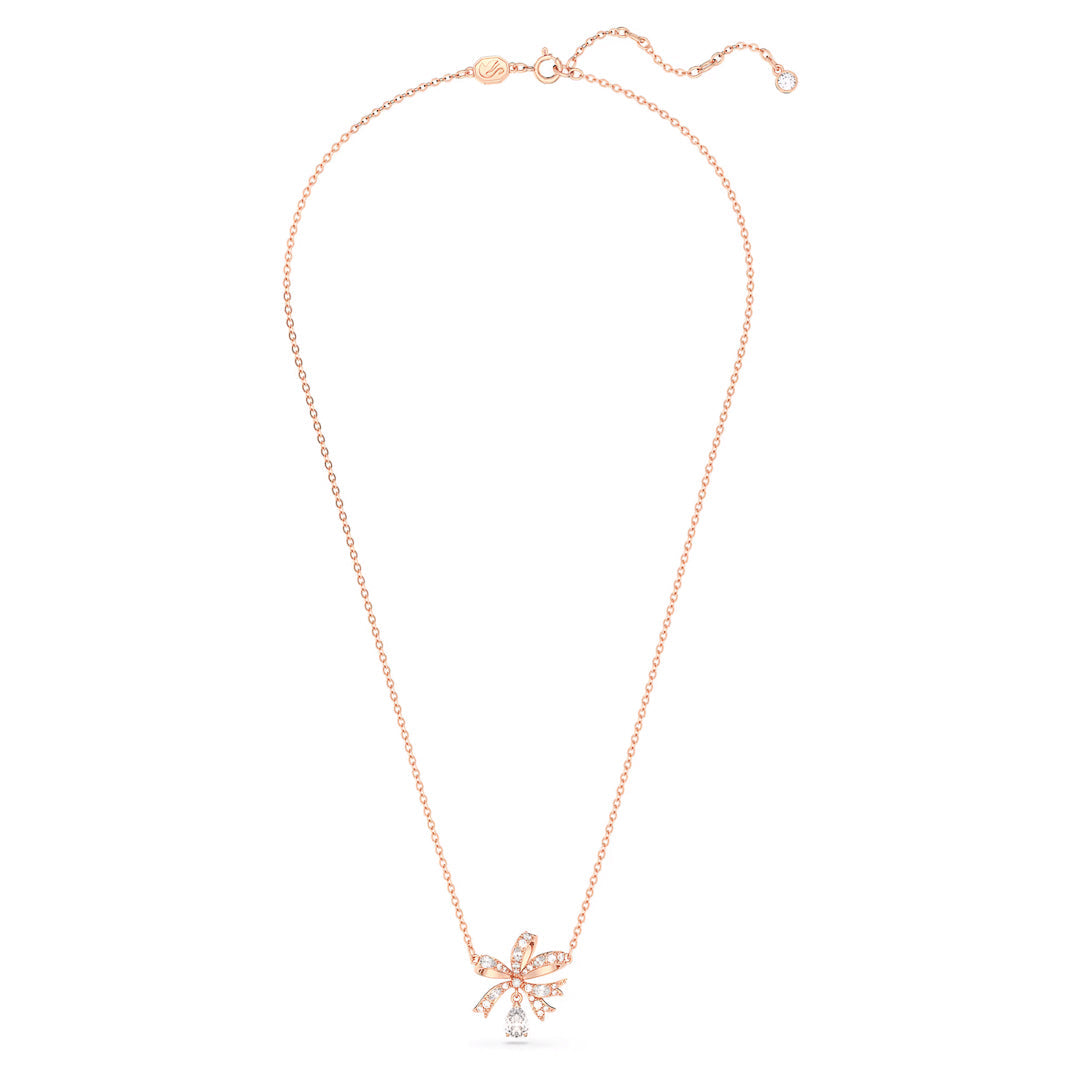 The Swarovski Hyperbola Necklace Pendant by Swarovski is a rose gold-tone plated necklace featuring a delicate chain, adorned with a bow-shaped pendant embellished with clear crystals, and elegantly finished with a single crystal drop hanging below.