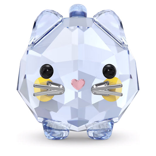 The Swarovski Chubby Blue Cat Home Décor piece beautifully captures a chubby cat with its crystal-clear, faceted surface. It features a light blue body, black eyes, a pink heart-shaped nose, silver whiskers, and yellow cheeks, standing upright like a dazzling gemstone.