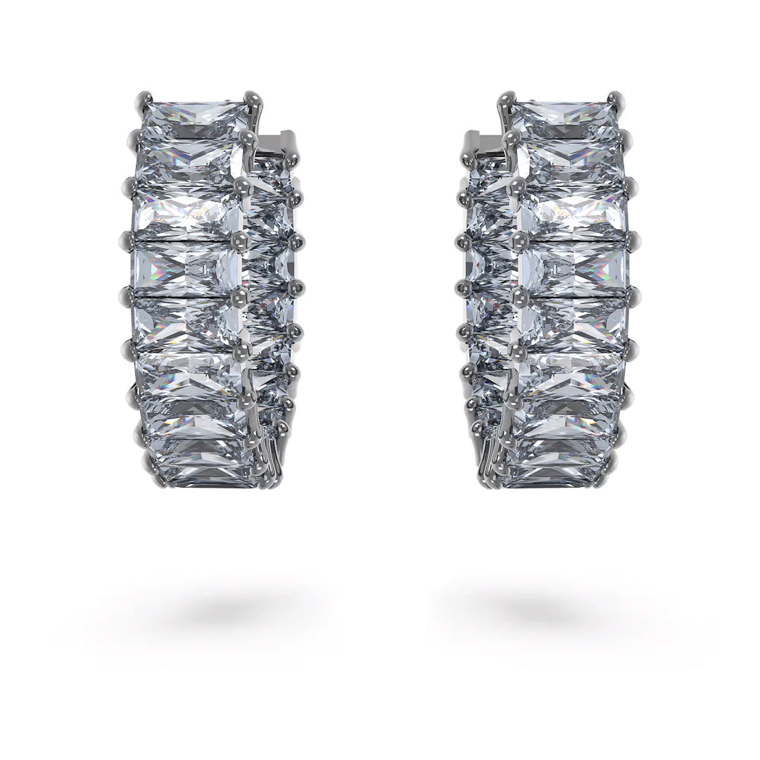 Presenting the Swarovski Matrix Hoop Earrings, a stunning pair of silver mini hoops adorned with princess-cut stones that form a continuous line around each earring, sparkling beautifully against a plain white background.