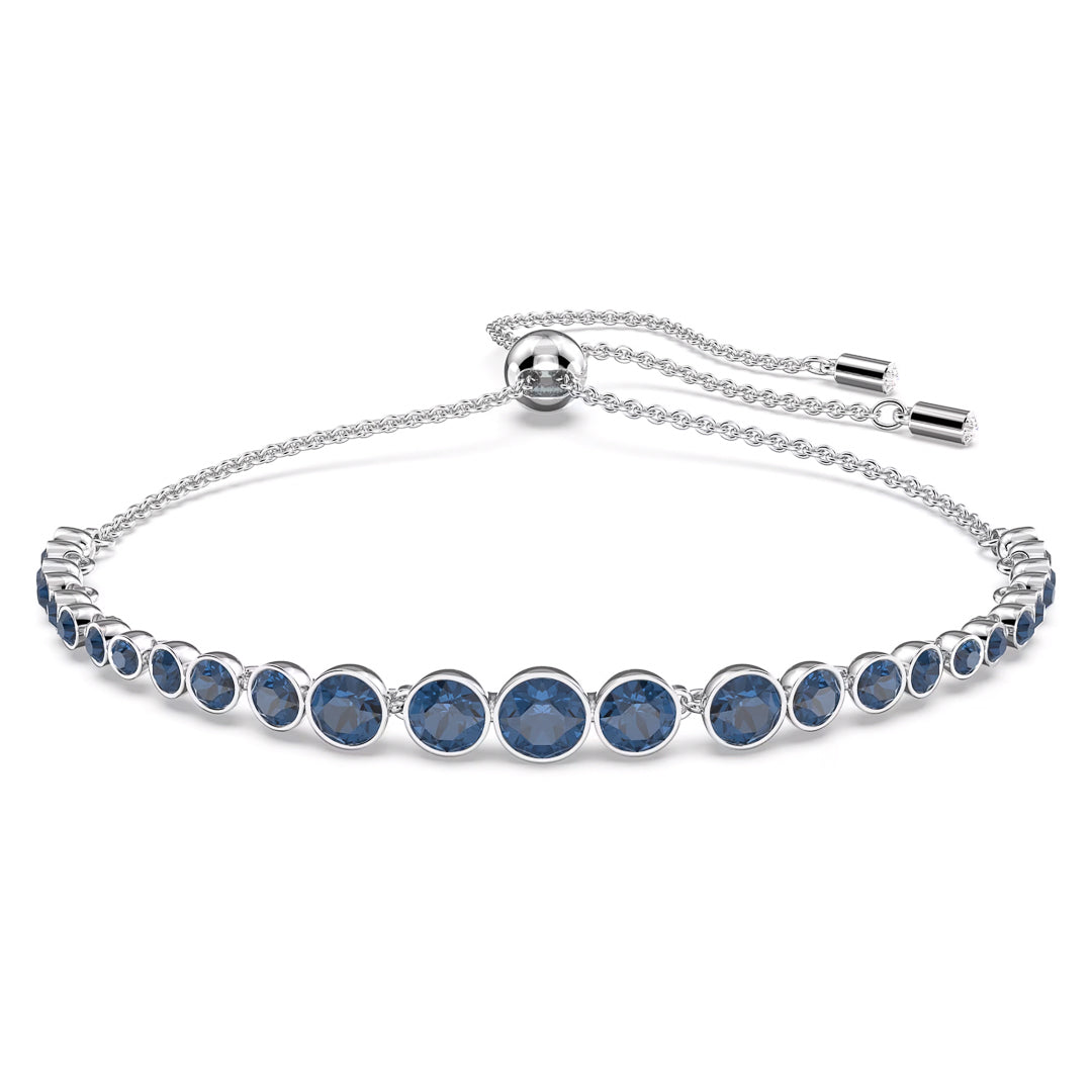 The Swarovski Imber Emily Bracelet showcases a rhodium-plated design with a sliding clasp, adorned with round blue crystals set in individual circular mounts arranged in a symmetrical pattern.