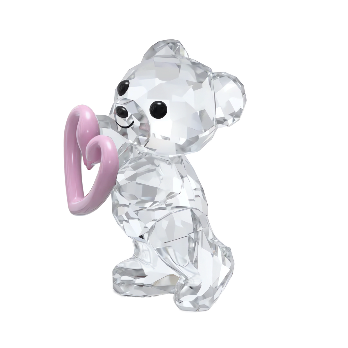 Swarovski’s Kris Bear Una Bear Style Number features a faceted crystal bear figurine with black eyes and nose, holding a shiny pink heart. This authentic Swarovski collectible is showcased against a white background.