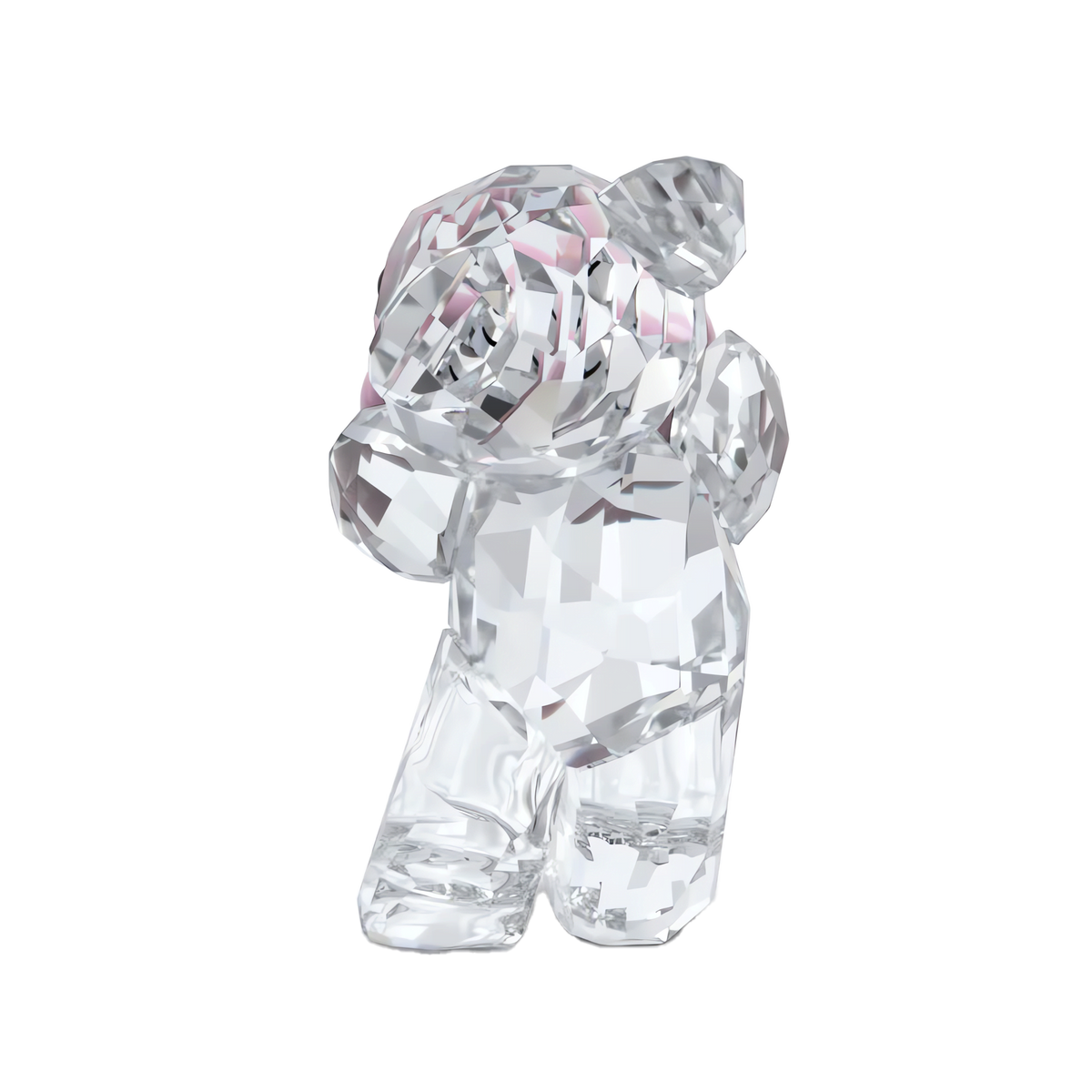 A clear, faceted crystal figurine from Swarovski— the Kris Bear Una Bear Style Number—stands upright with subtle pink accents near the ears, showcased against a plain white background; this authentic piece embodies the charm and exceptional craftsmanship that collectors admire in Swarovski creations.