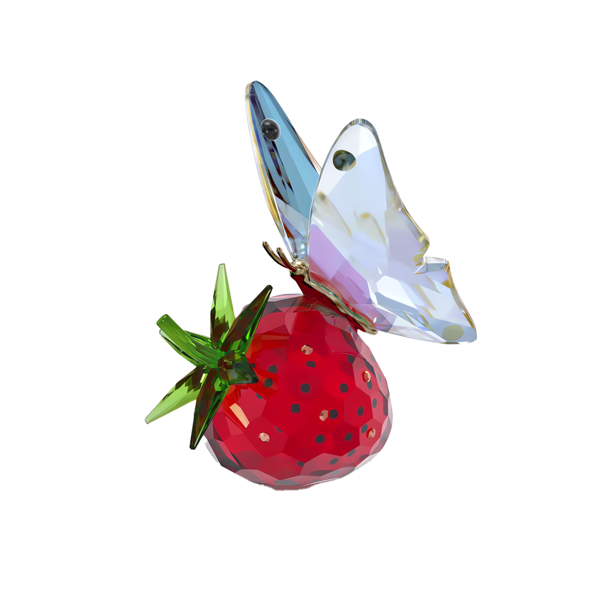 The Swarovski Idyllia Butterfly and Strawberry by Swarovski features a faceted crystal sculpture of a vibrant red strawberry with green leaves and intricate crystalline facets, topped with a translucent butterfly, creating an exquisite piece of butterfly home décor set against a plain white background.