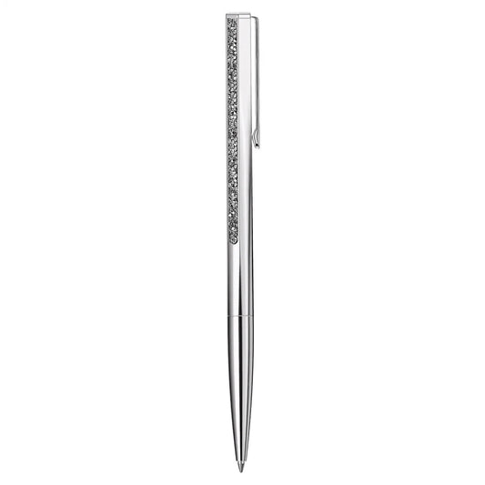 Introducing the Swarovski Crystal Shimmer Ballpoint Pen, a luxurious writing instrument by Swarovski. This sleek silver pen boasts a polished metallic finish and an elegant tapered design, adorned with a decorative strip of small Crystal Rocks along its clip side.
