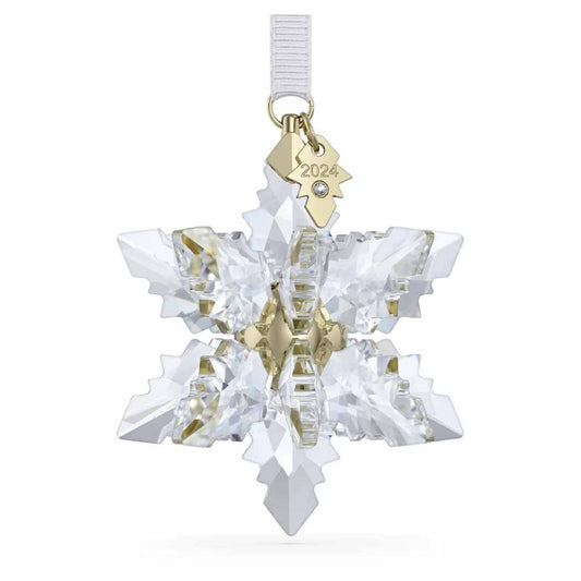 The Swarovski 2024 Annual Editions 3D Ornament Home Décor showcases a breathtaking 3D snowflake design with a gold metal center and includes a golden tag engraved with "2024." This exquisite ornament gracefully hangs from a white ribbon, bringing timeless charm to your holiday decorations.