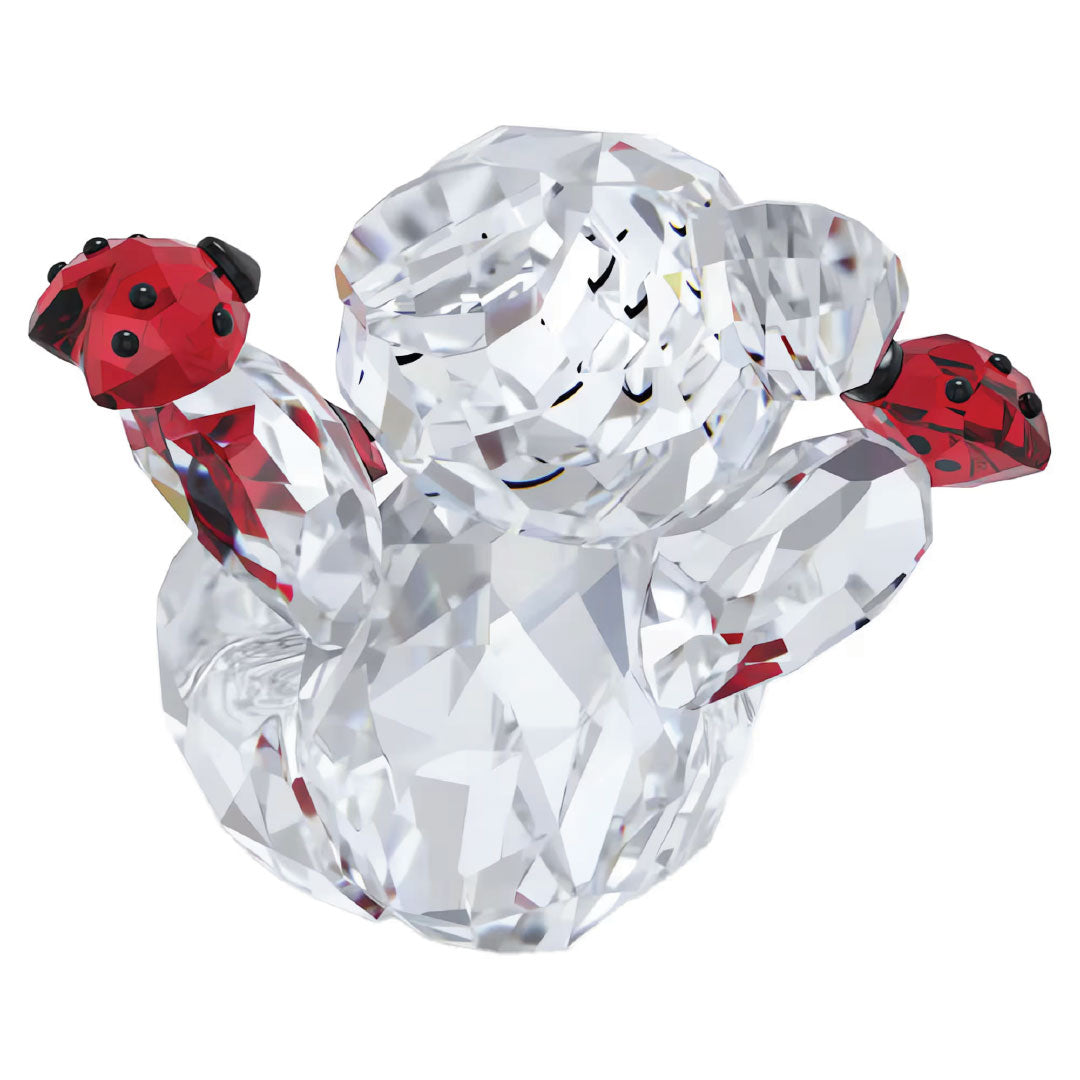 The Swarovski Kris Bear Good Luck Bear from Swarovski delightful holds two vibrant ladybugs, surrounded by beautifully light-reflecting facets. The transparent design of the bear accentuates the vivid red and black-spotted details of the insects, adding a charming touch to any home décor.