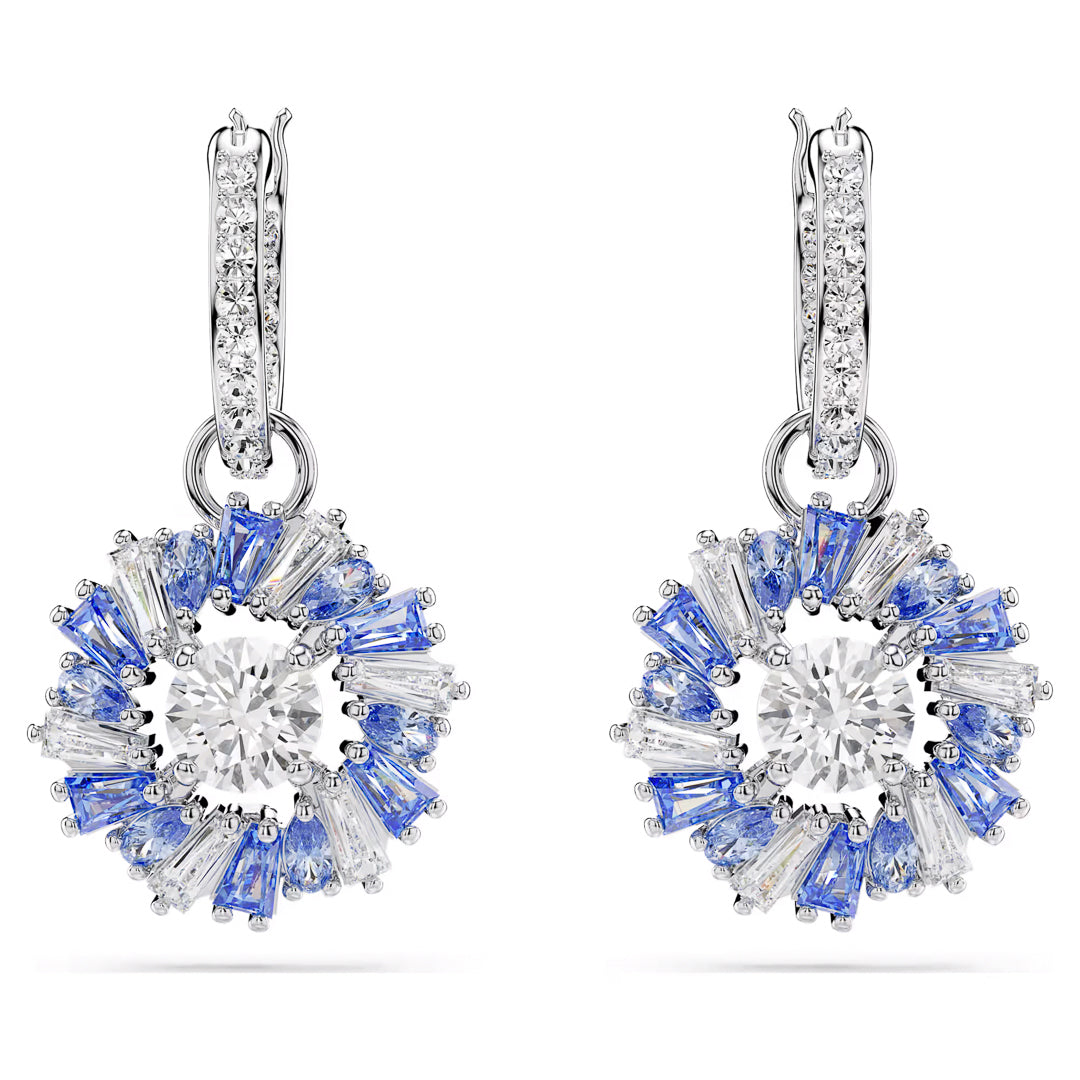 Experience the sophistication of Swarovski with our Idyllia Drop Earrings, featuring a floral design adorned with sparkling diamonds and blue gemstones. Each earring highlights a central round diamond surrounded by Swarovski Zirconia petals and is topped with a diamond-studded hoop.