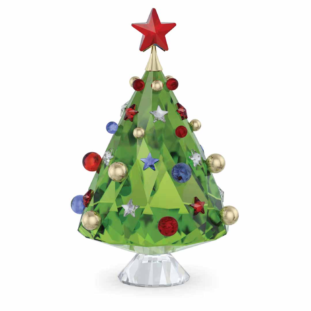 The Swarovski Holiday Cheers Tree Home Décor by Swarovski is a festive decorative piece featuring a green crystal holiday tree adorned with red, blue, and gold ornaments, all topped with a red star. This elegant centerpiece stands on a clear crystal base.