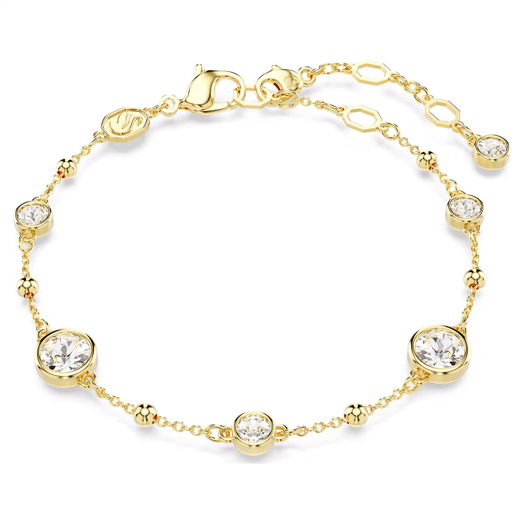 The Swarovski Imber Bracelet is a delicate gold-tone plated accessory from Swarovski, showcasing round-cut crystals elegantly set in bezels. Its design is enhanced with small gold beads and an adjustable chain featuring a lobster clasp, providing a touch of elegance to any outfit.