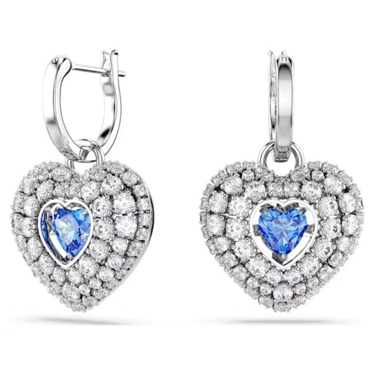 These stunning Swarovski Hyperbola Blue Heart Drop Earrings from Swarovski are rhodium-plated and feature a central blue gemstone set in a heart shape, encrusted with sparkling stones. The hoop design enhances their elegance and sophistication, while the Swarovski Zirconia adds to their radiant charm.