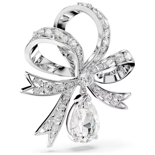 The Swarovski Hyperbola Bow Brooch, rhodium-plated and adorned with Swarovski Zirconia, features a bow design with a teardrop-shaped diamond gracefully hanging at its center. Its meticulous craftsmanship and polished finish make it undeniably captivating.