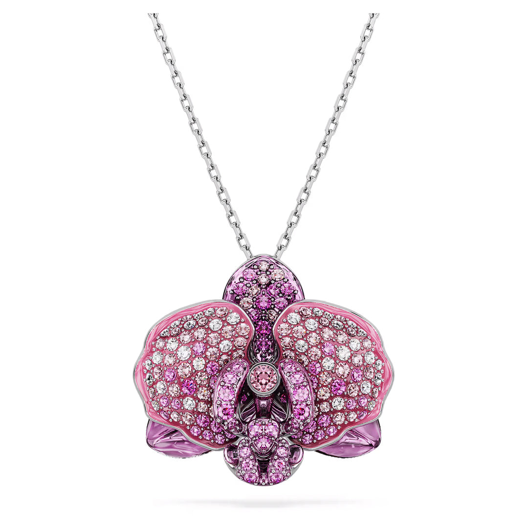 Introducing the Swarovski Idyllia Necklace Pendant: a stunning piece from Swarovski featuring a silver necklace adorned with an orchid-shaped flower motif. The pendant is encrusted with pink and white crystals, and its intricate design elegantly highlights the petals with a gradient of sparkling colors for a luxurious appearance.