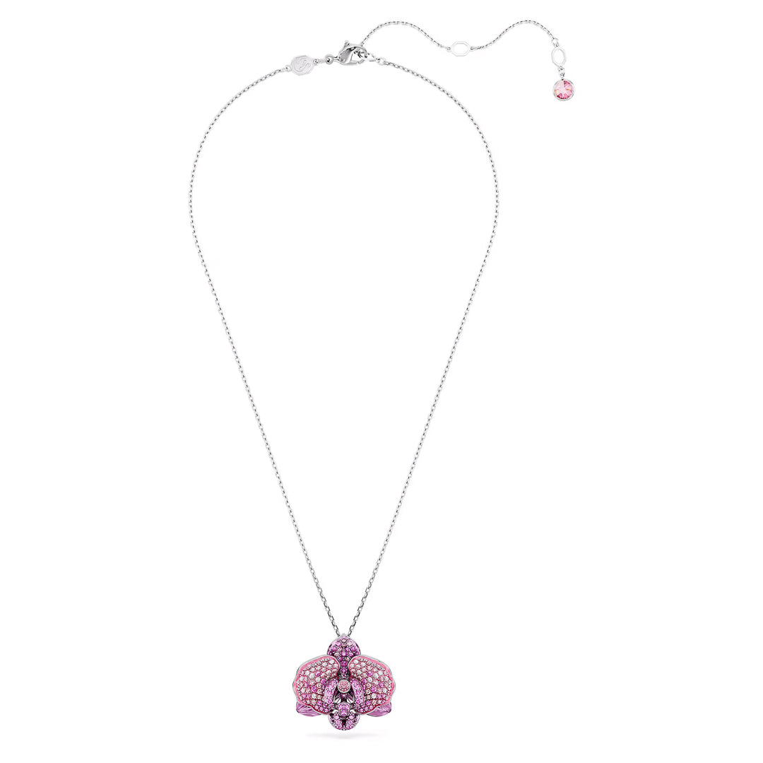 The exquisite Swarovski Idyllia Necklace Pendant showcases a butterfly embellished with pink and purple gemstones on a silver chain, enhanced by an adjustable clasp featuring a small pink gem. The design elegantly integrates a floral motif, enhancing its charming elegance.