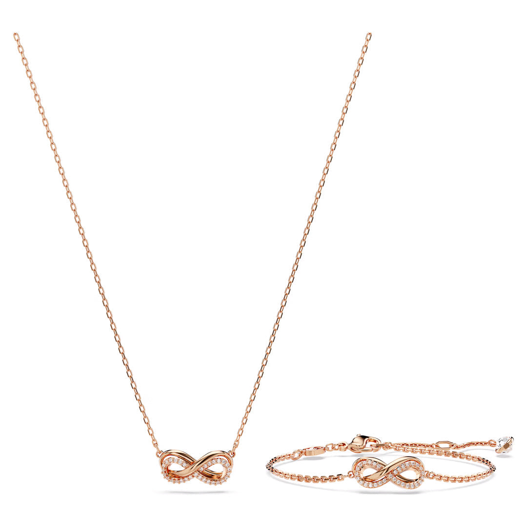 The Swarovski Hyperbola Necklace Pendant and Bracelet Set is a delicate jewelry collection featuring an infinity symbol necklace and matching bracelet, both plated in rose gold-tone. The thin chains of both pieces are elegantly accented with small crystals on the infinity symbols, embodying the sophistication of Swarovski.