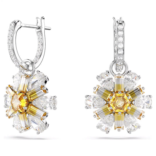 The Swarovski Idyllia Drop Earrings, crafted by Swarovski, feature an exquisite floral design. The petals are formed by elongated yellow Swarovski Zirconia stones and are beautifully encircled by teardrop-shaped clear stones. These elements are set in rhodium-plated silver hoops that are adorned with smaller clear gemstones.