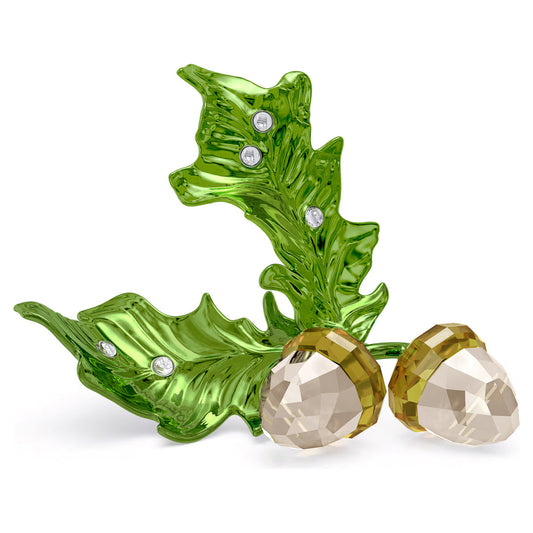 Part of the Swarovski Idyllia Collection, the Swarovski Idyllia Acorns Home Décor piece showcases two crystal acorns with brown tops resting on a green glass leaf. This elegant leaf is adorned with small, clear crystal accents that add a touch of sparkle to the design, making it an ideal seasonal creation.