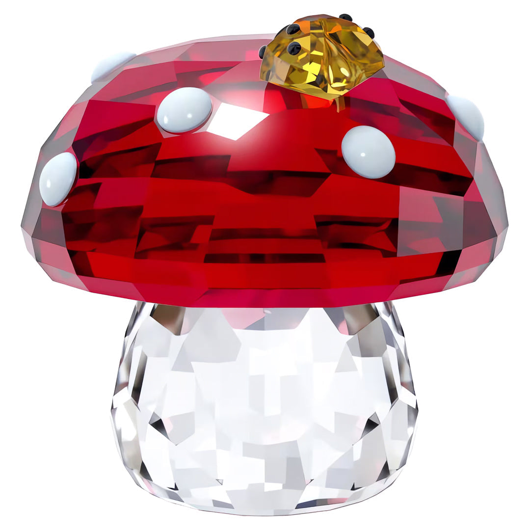 As part of the Swarovski Idyllia Mushroom and Ladybugs Home Décor, this crystal figurine showcases a spotted mushroom with a faceted red cap adorned with white dots. A delicate yellow ladybug graces the top, while its clear, multi-faceted stem brilliantly reflects light.