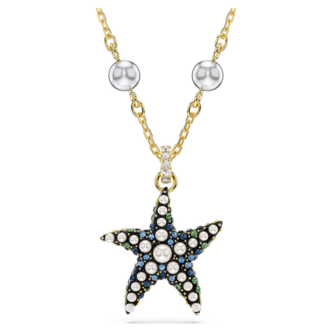 The Swarovski Idyllia Necklace Pendant by Swarovski offers an ocean-inspired jewelry theme with its gold necklace featuring a star-shaped pendant. The pendant, reminiscent of a starfish, is beautifully adorned with pearls and small blue and green gemstones. The chain includes decorative pearl-like elements, completing the sophisticated look of the Crystal Pearls necklace.