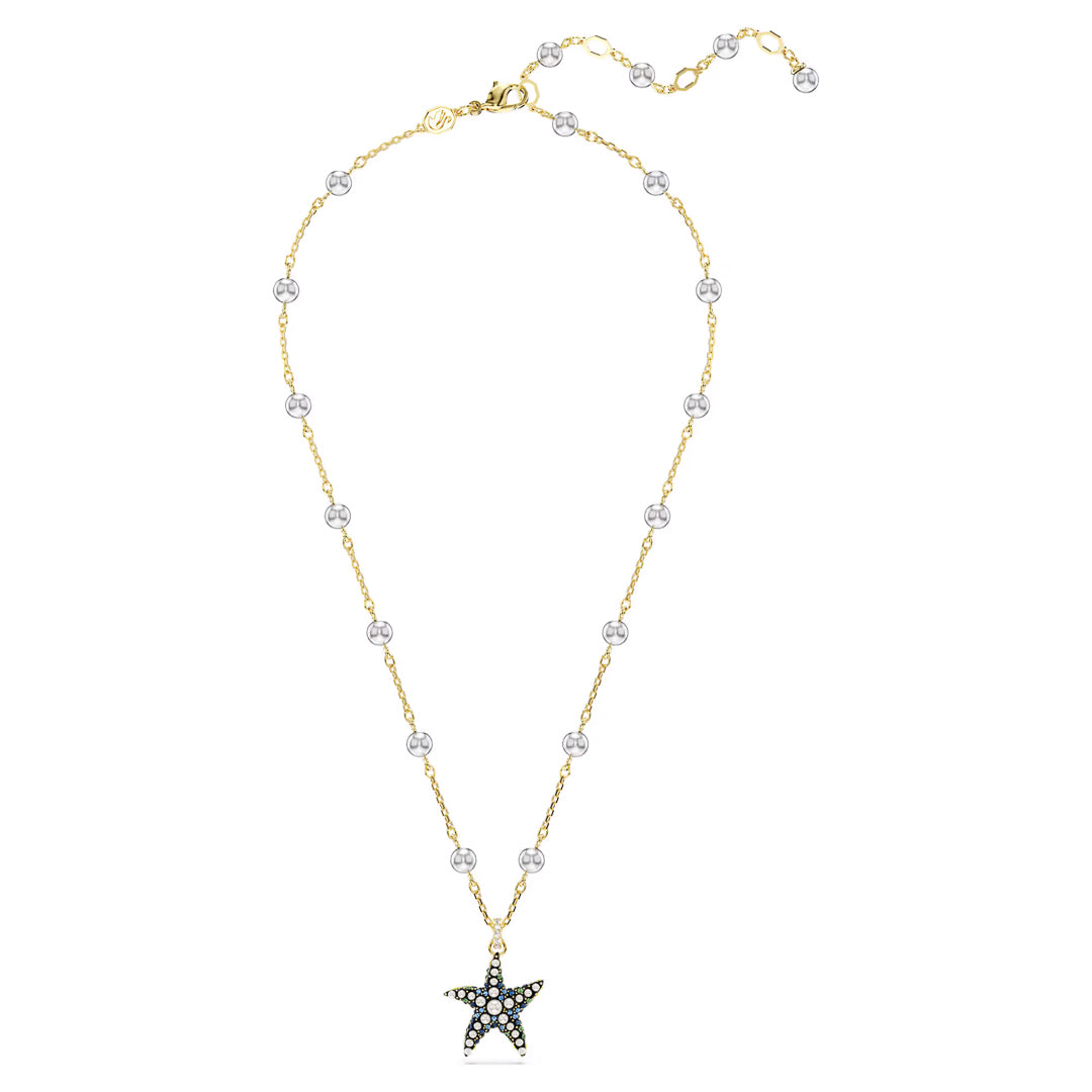 The Swarovski Idyllia Necklace Pendant by Swarovski is a gold chain necklace featuring crystal pearls and white beads, complete with an ocean-inspired starfish pendant adorned with turquoise and black stones.