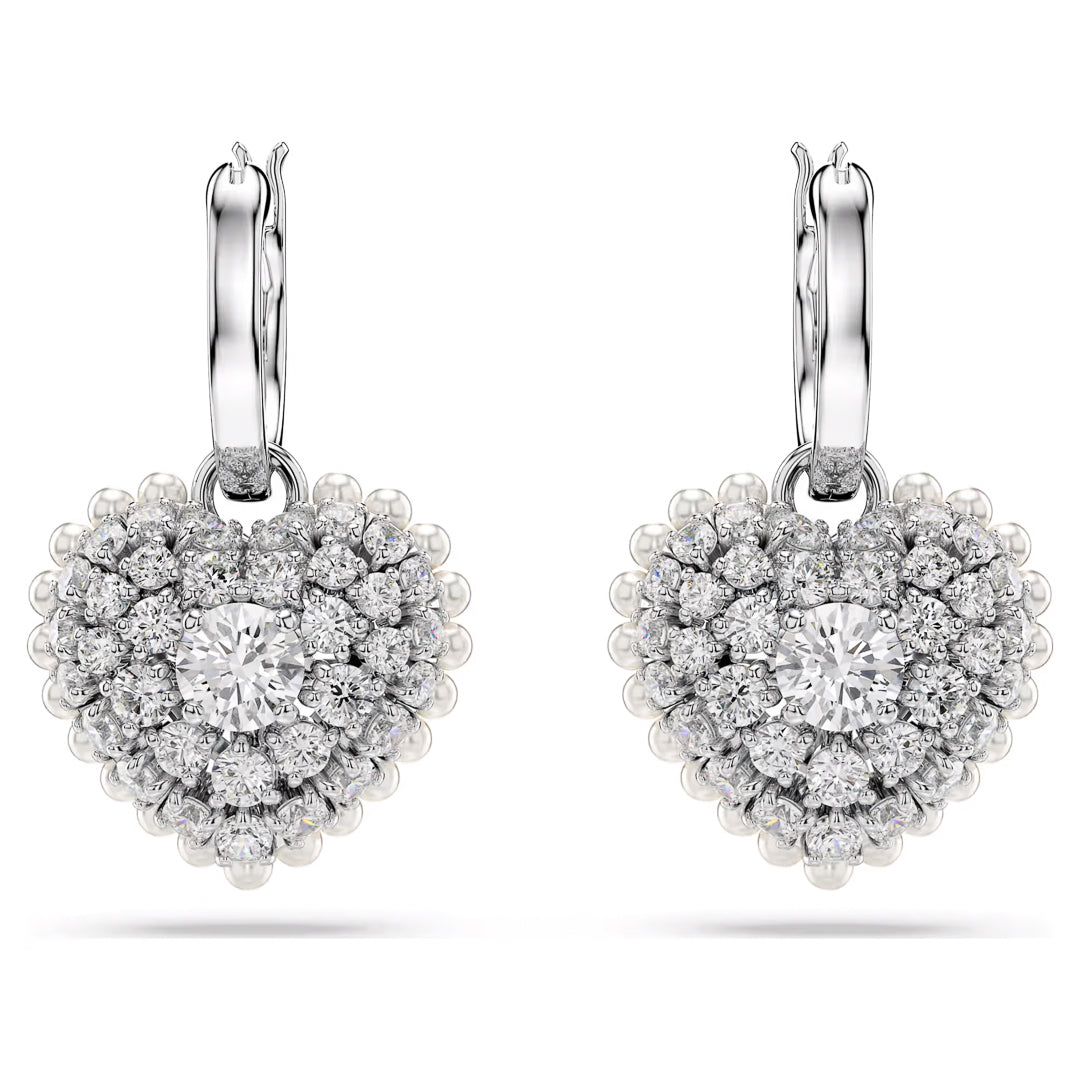 The Swarovski Hyperbola Heart Drop Earrings by Swarovski boast a sophisticated and luxurious design, with heart-shaped earrings embellished with shimmering Swarovski Zirconia. They feature a prominent central gemstone encircled by smaller stones for added elegance.