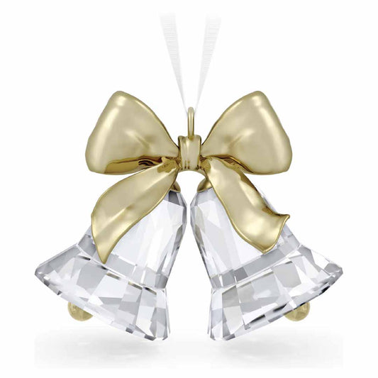 The Swarovski Holiday Magic Bells Ornament Home Décor features crystallized bells adorned with a gleaming champagne gold-tone metal bow and hangs gracefully from a white ribbon.
