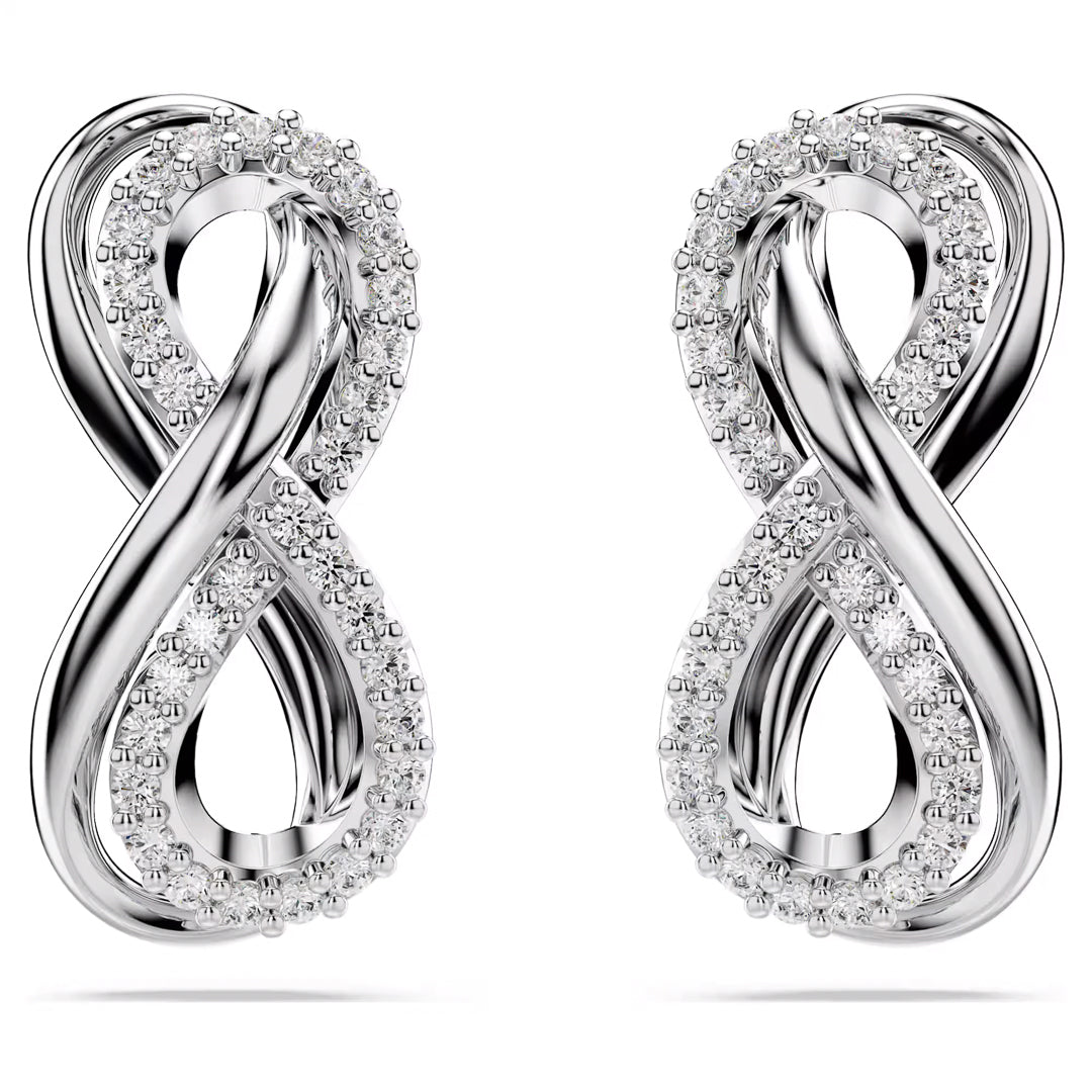The Swarovski Hyperbola Stud Earrings, by the renowned brand Swarovski, are crafted in rhodium-plated silver and feature elegant figure-eight shapes adorned with embedded Swarovski Zirconia stones. The intertwined design reflects light beautifully, creating a luxurious and sophisticated appearance.