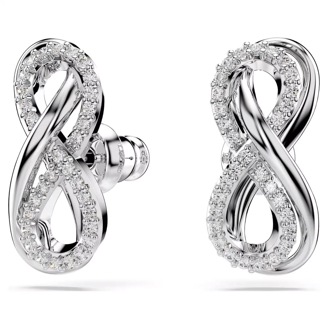 Explore the Swarovski Hyperbola Stud Earrings, a sophisticated pair of rhodium-plated silver earrings embellished with small sparkling diamonds. These elegant accessories, crafted by Swarovski, showcase a stunning polished finish and stud backings that enhance any outfit with their refined elegance.