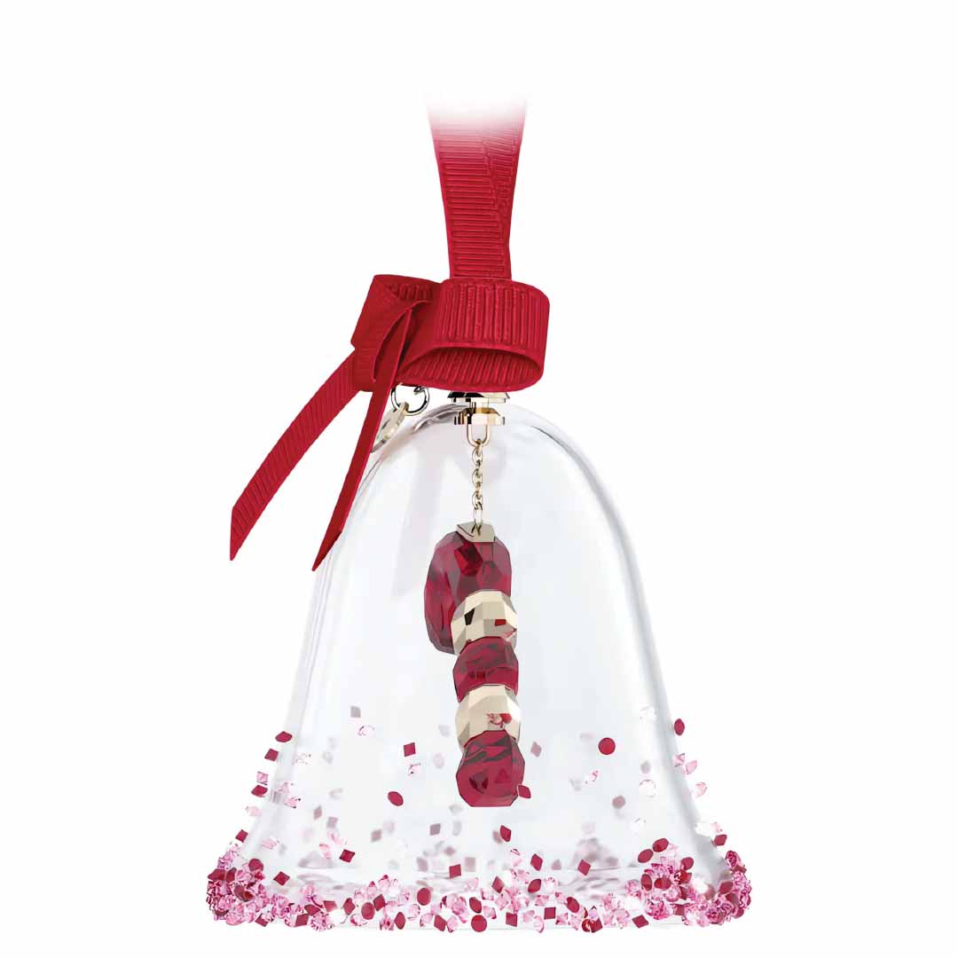 The Swarovski Holiday Cheers Dulcis Bell Ornament by Swarovski is a captivating centerpiece for any celebration, featuring a crystal-clear, bell-shaped design with a vibrant red ribbon at the top. Inside, abstract red and white beads dangle gracefully like festive whispers. The base is beautifully embellished with red and white confetti-like accents.