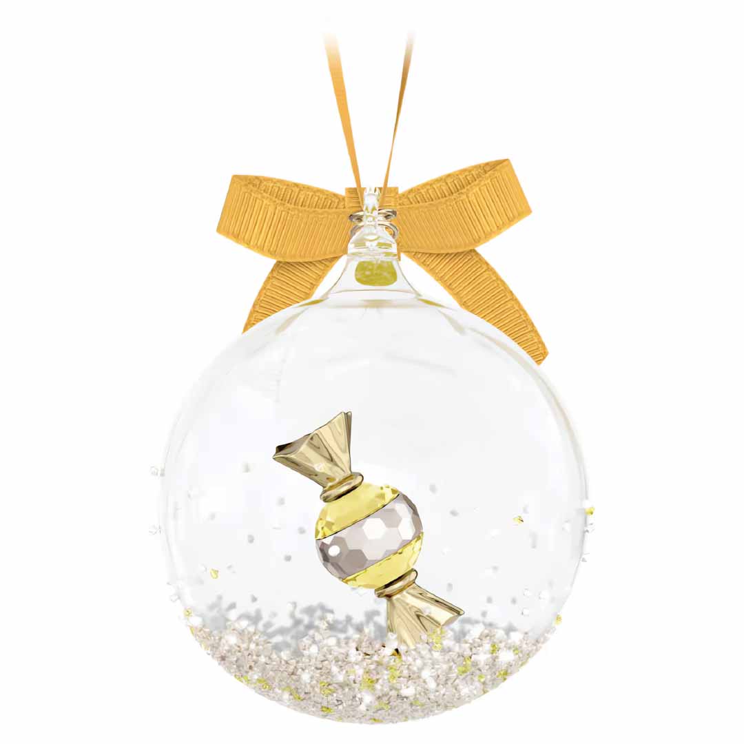 This exquisite ornament from Swarovski, the Holiday Cheers Dulcis Bell Ornament Home Décor, features a clear glass design adorned with a gold ribbon and loop for hanging. Inside, a gold candy-shaped decoration is beautifully surrounded by silver and gold glitter, offering a festive and elegant touch to your holiday decor.
