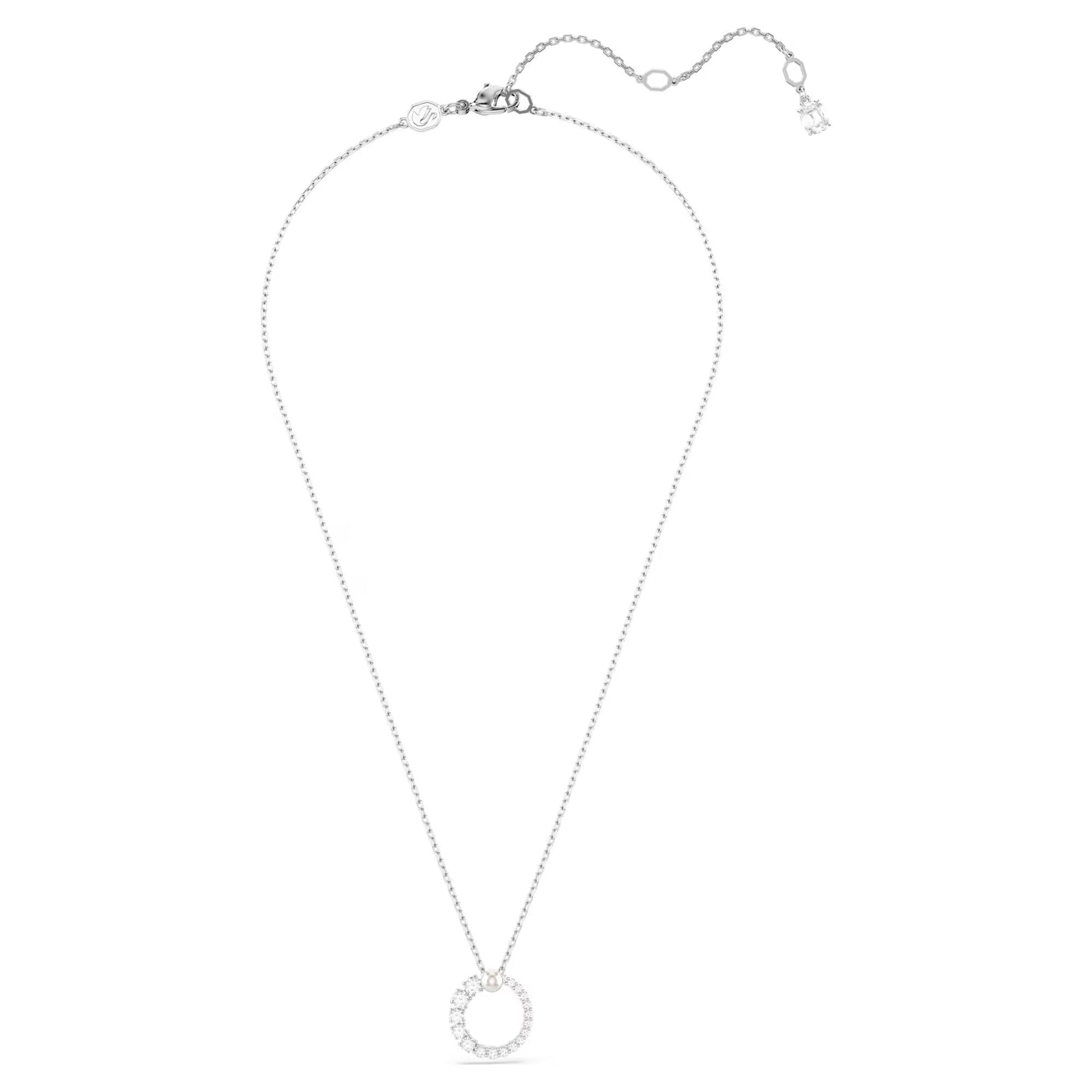 The Swarovski Matrix Necklace Pendant features a delicate chain with a circular pendant adorned with small, sparkling Swarovski Zirconia gemstones. It includes an adjustable clasp and a small charm at the end, capturing an elegant and minimalistic design.