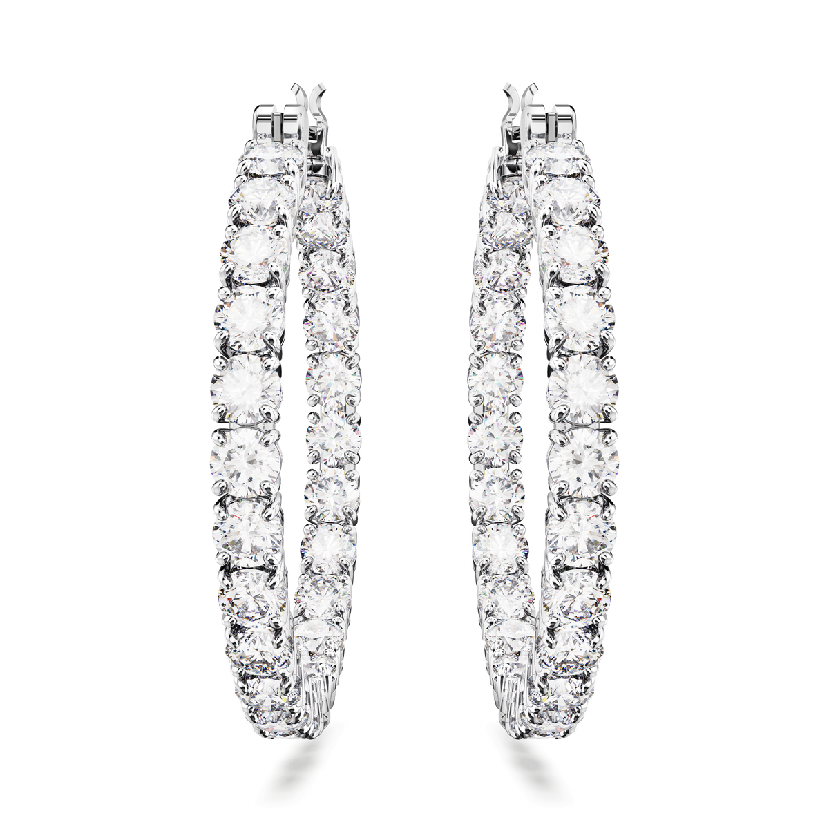 A pair of Swarovski Matrix hoop earrings, featuring large, round-cut clear stones and rhodium plating, displayed on a plain white background.