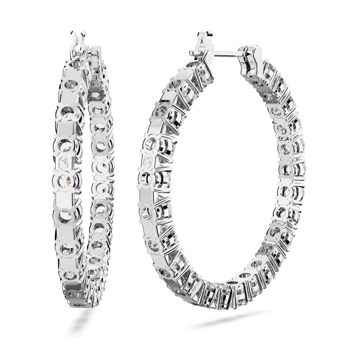 Two Swarovski Matrix hoop earrings, large and rhodium plated, featuring round white stones, are displayed on a white background; one earring shows its side profile while the other is forward-facing.