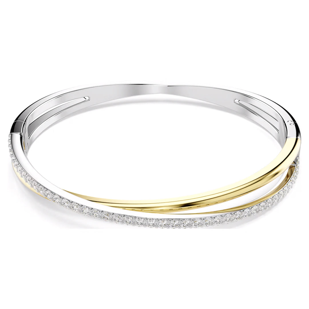 As a piece from the Swarovski Hyperbola collection, this elegant bangle features an intricate design with silver and gold weaving around a row of dazzling diamonds, all set against a pristine white backdrop.