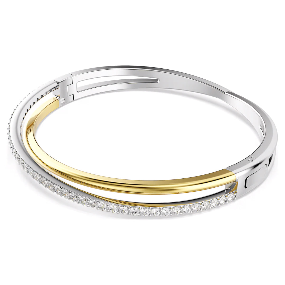 Introducing the Swarovski Hyperbola Bangle, a chic accessory from the renowned Swarovski brand. This bangle boasts a sophisticated design with alternating bands of silver and gold. One side sparkles with small, dazzling clear stones, demonstrating signature elegance from the Swarovski collection.
