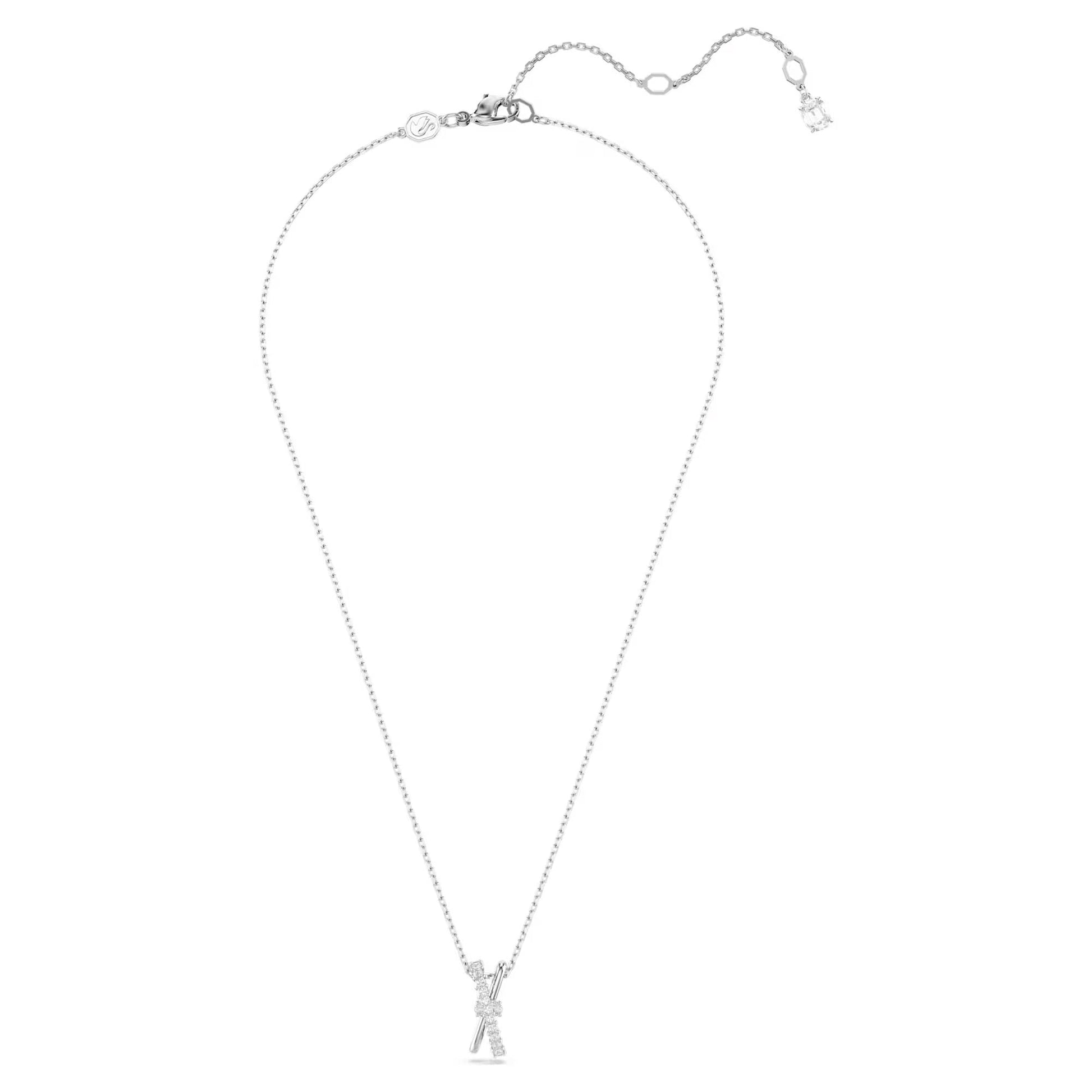 The Swarovski Hyperbola Necklace Pendant is an exquisite piece from the iconic Swarovski brand. This delicate silver necklace is accentuated by a handbag-shaped pendant adorned with small crystals. It features an adjustable chain with a clasp and a sparkling Swarovski Zirconia detail near the fastener.
