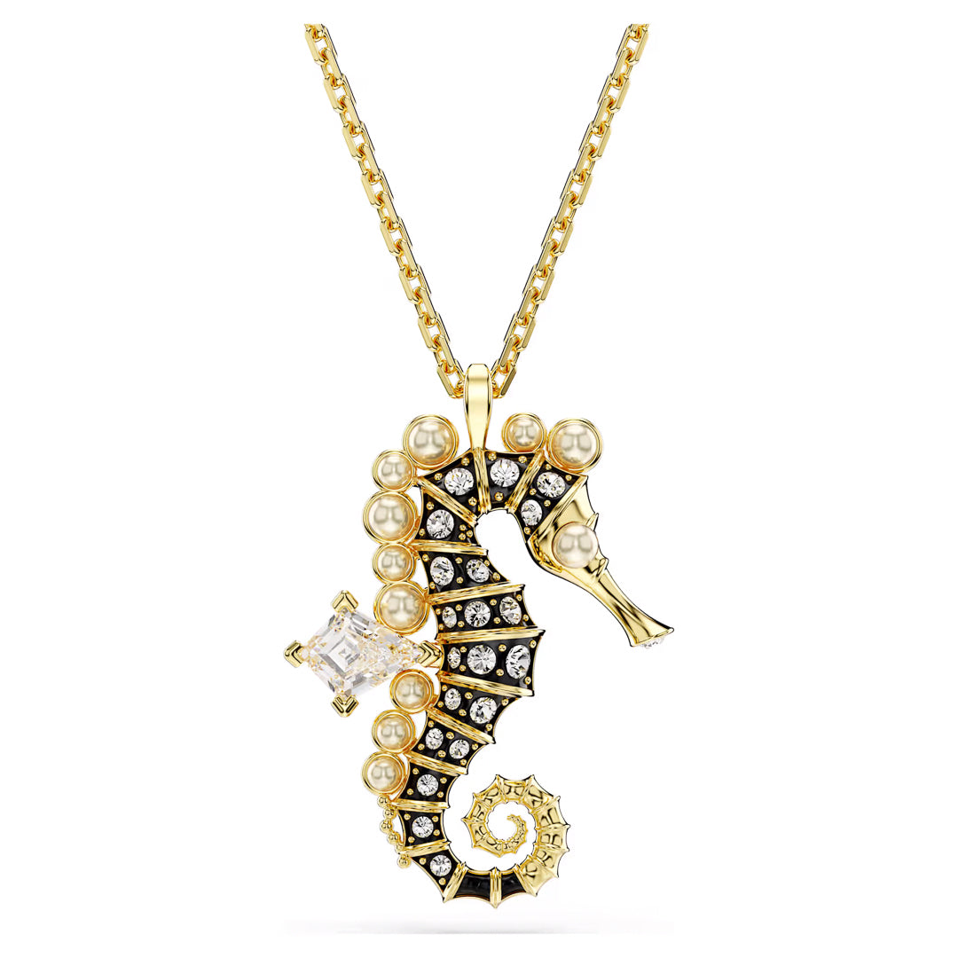 The Swarovski Idyllia Necklace Pendant features a seahorse adorned with pearls and sparkling Swarovski Zirconia. Detailed with a spiral tail and an elegant oceanic motif, it hangs from a fine gold chain. Brought to you by Swarovski.
