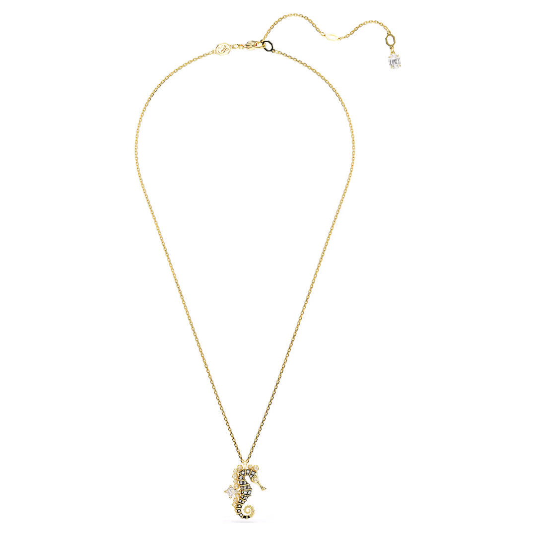 The Swarovski Idyllia Necklace Pendant by Swarovski is a delicate gold necklace adorned with a seahorse pendant encrusted with dazzling Swarovski Zirconia stones. This ocean-inspired piece includes an adjustable clasp and is elegantly finished with a small dangling stone for added sophistication.